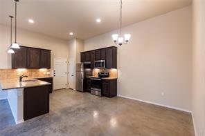351 Joanne Loop, Unit A Buda, TX 78610 - Photo 2 of 17 A well-lit, open-concept kitchen and dining area provides ample space for entertaining.