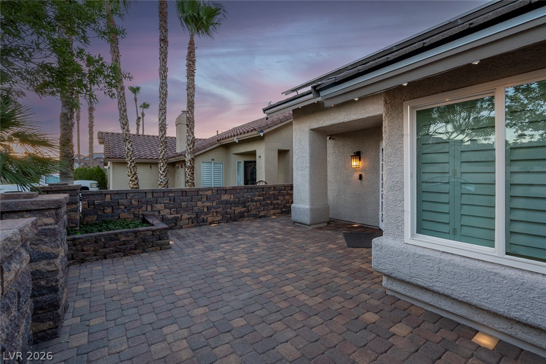 818 Manor Shores Road Henderson, NV 89002 - Photo 4 of 35 A welcoming paver courtyard with tiered stone landscaping leads to the inviting home entrance.