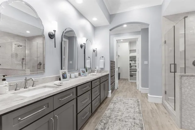 a spacious bathroom with a double vanity sink and a mirror