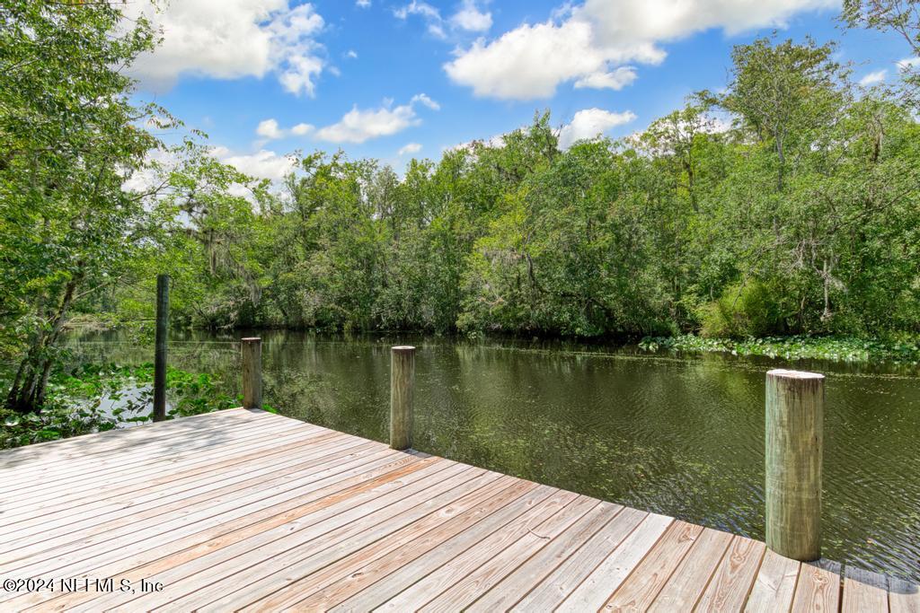 8225 Hardwood Landing Road St. Augustine, FL 32092 - Photo 103 of 126 a wooden pier with boats in a lake