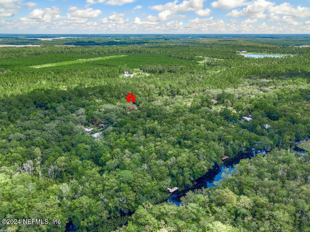 8225 Hardwood Landing Road St. Augustine, FL 32092 - Photo 114 of 126 a backyard of a house with lots of green space and a lake view