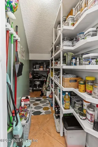 a view of a house with backyard sitting area and garden