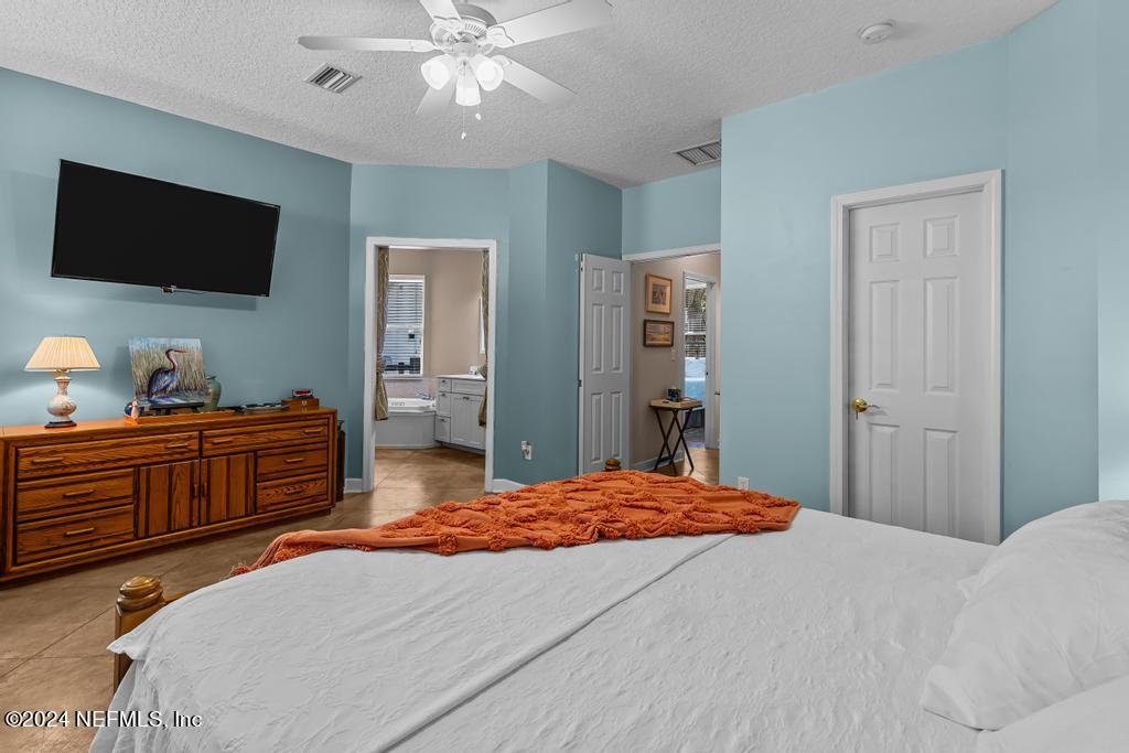8225 Hardwood Landing Road St. Augustine, FL 32092 - Photo 25 of 126 a bedroom with a bed and a flat screen tv