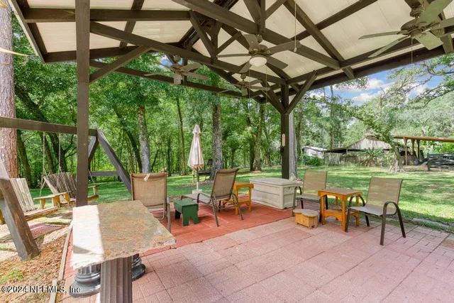 an aerial view of a house with a yard basket ball court and outdoor seating