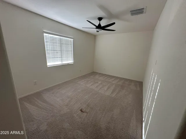 an empty room with a empty space and windows