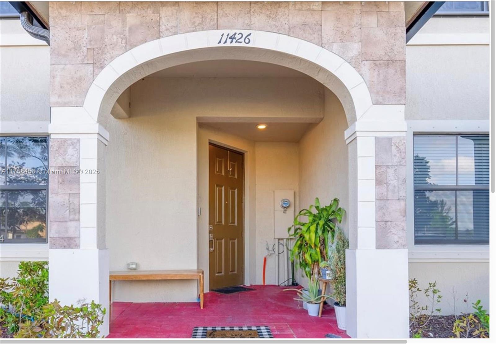 11426 West 33rd Way Hialeah, FL 33018 - Photo 1 of 14 a potted plant sitting in front of a door