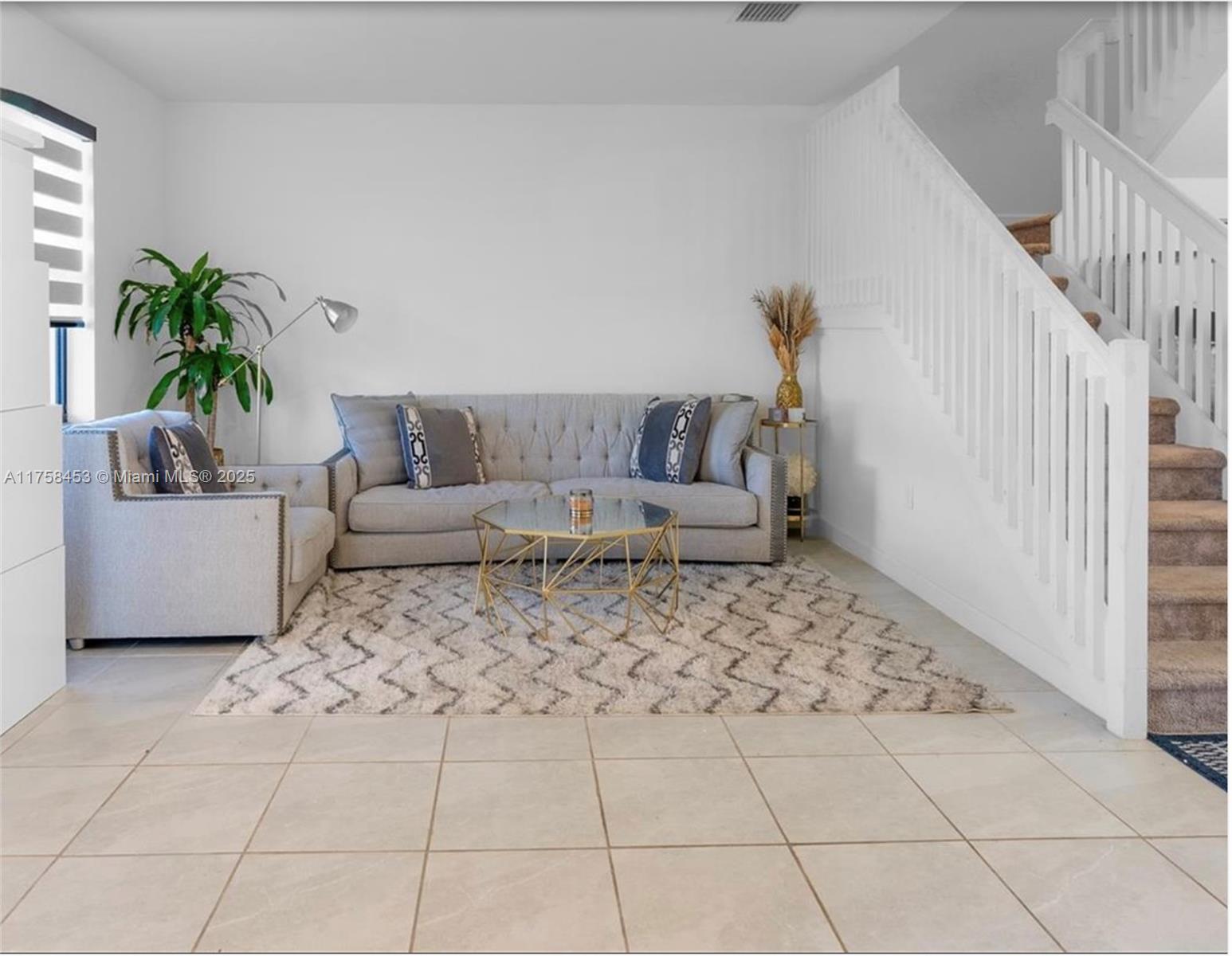 11426 West 33rd Way Hialeah, FL 33018 - Photo 4 of 14 a living room with a couch and a potted plant
