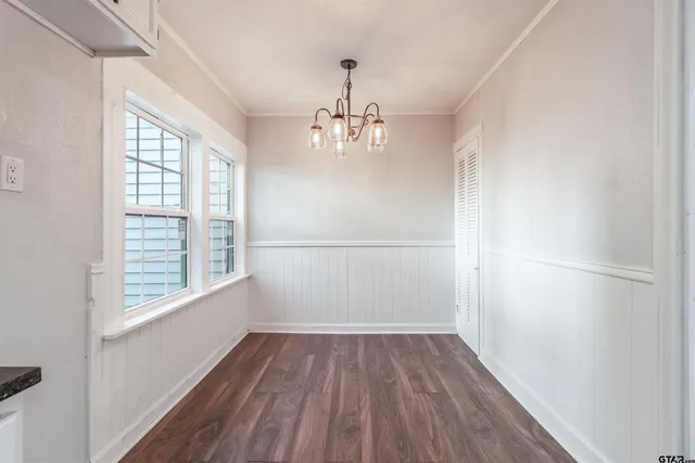 a view of a room with wooden floor closet and windows