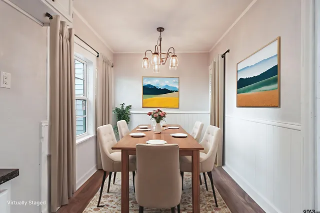 a dining room with furniture window wooden floor and a chandelier