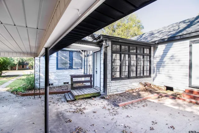 a view of a porch with furniture and a backyard