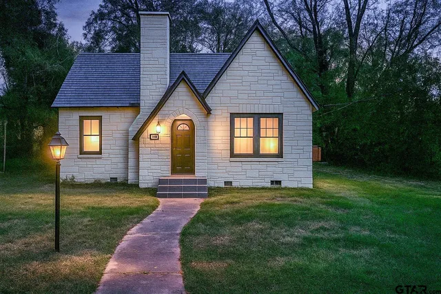 a view of a brick house with a yard