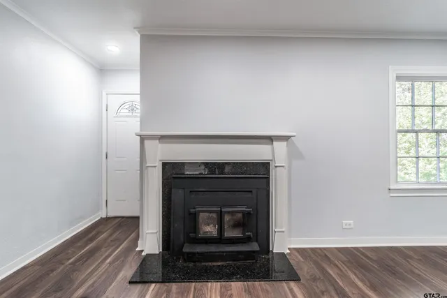 a living room with a fireplace and a wooden floor