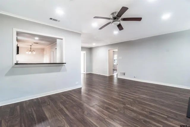 a view of a room with wooden floor and white walls