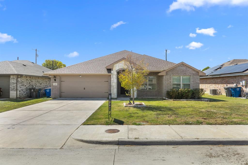 14580 Gully Place Dallas, TX 75253 - Photo 4 of 30 a front view of a house with a yard and garage