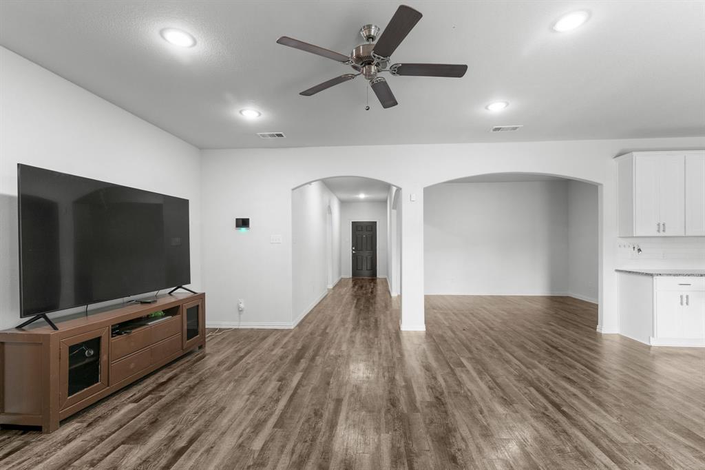 14580 Gully Place Dallas, TX 75253 - Photo 8 of 30 a view of a livingroom with wooden floor and a ceiling fan