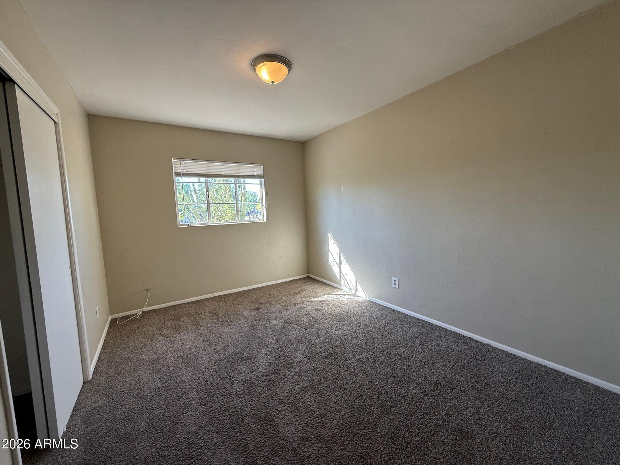 4447 East Almeria Road Phoenix, AZ 85008 - Photo 5 of 9 an empty room with windows