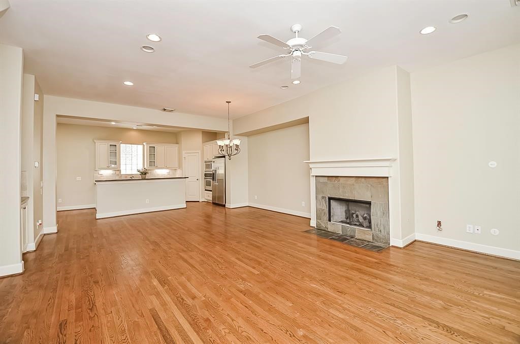 222 Knox Street, Unit F Houston, TX 77007 - Photo 11 of 36 a view of empty room with wooden floor and fireplace