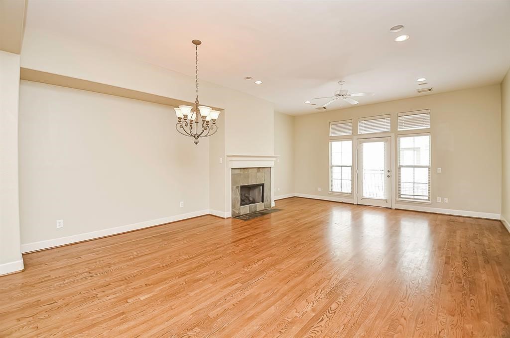 222 Knox Street, Unit F Houston, TX 77007 - Photo 12 of 36 a view of empty room with wooden floor and fireplace
