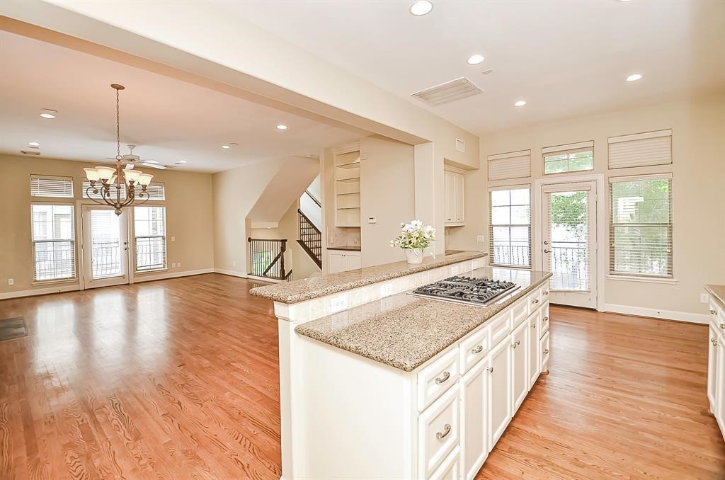 222 Knox Street, Unit F Houston, TX 77007 - Photo 18 of 36 a kitchen with a stove and a wooden floors