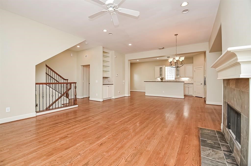 222 Knox Street, Unit F Houston, TX 77007 - Photo 10 of 36 an empty room with wooden floor and way to kitchen