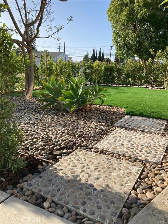 8312 Barnsley Avenue Los Angeles, CA 90045 - Photo 16 of 17 a backyard of a house with lots of green space