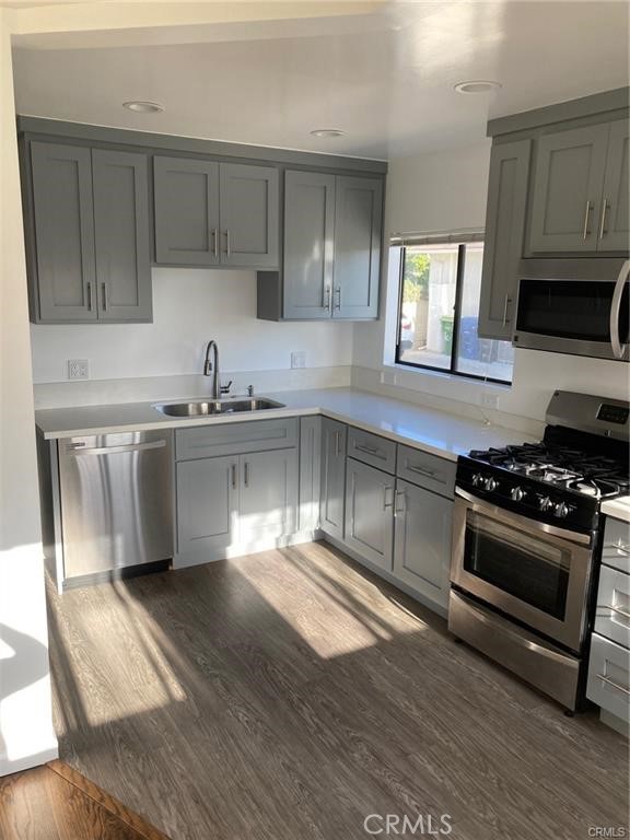 8312 Barnsley Avenue Los Angeles, CA 90045 - Photo 4 of 17 a kitchen with stainless steel appliances a sink stove and cabinets