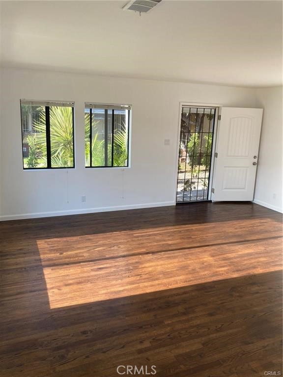 8312 Barnsley Avenue Los Angeles, CA 90045 - Photo 8 of 17 a view of an empty room with wooden floor and a window