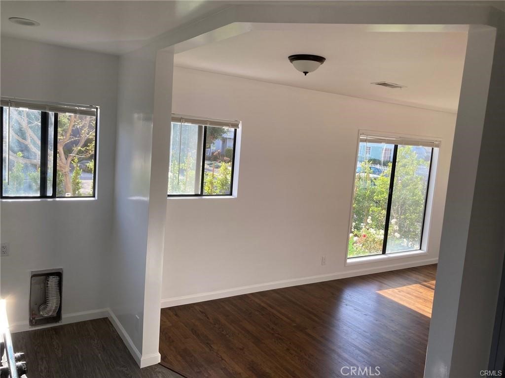 8312 Barnsley Avenue Los Angeles, CA 90045 - Photo 9 of 17 a view of an empty room with wooden floor and a window