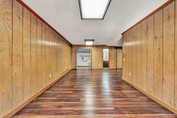 a view of a livingroom with wooden floor and a fireplace