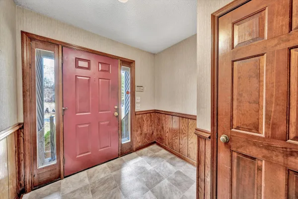 a living room with furniture fireplace and wooden floor