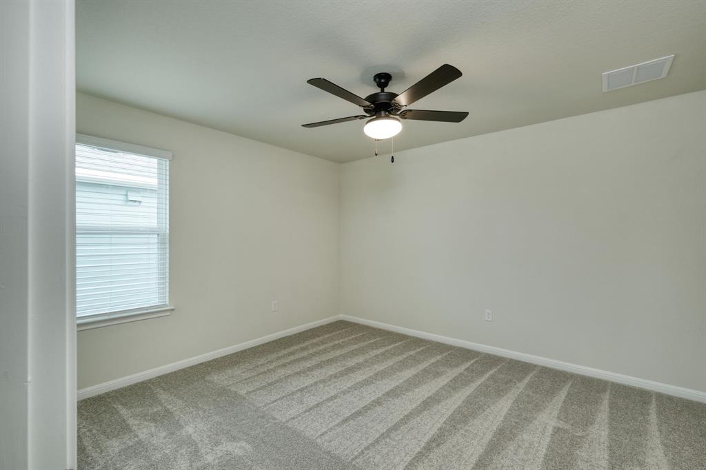 8307 Haflinger Drive Austin, TX 78747 - Photo 7 of 13 Empty room featuring carpet floors and ceiling fan