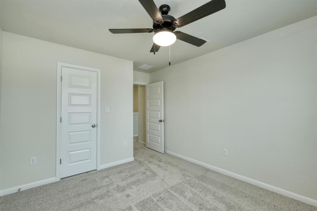 8307 Haflinger Drive Austin, TX 78747 - Photo 8 of 13 Unfurnished bedroom featuring carpet and a ceiling fan