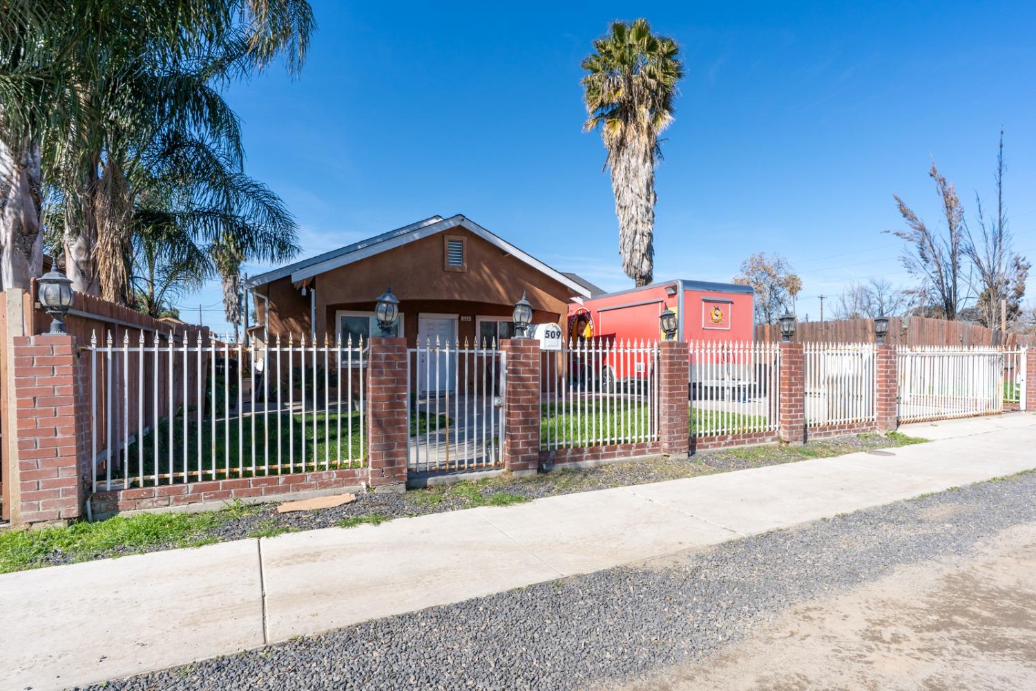 509 Kerr Avenue Modesto, CA 95354 - Photo 1 of 55 a front view of a house with a garden