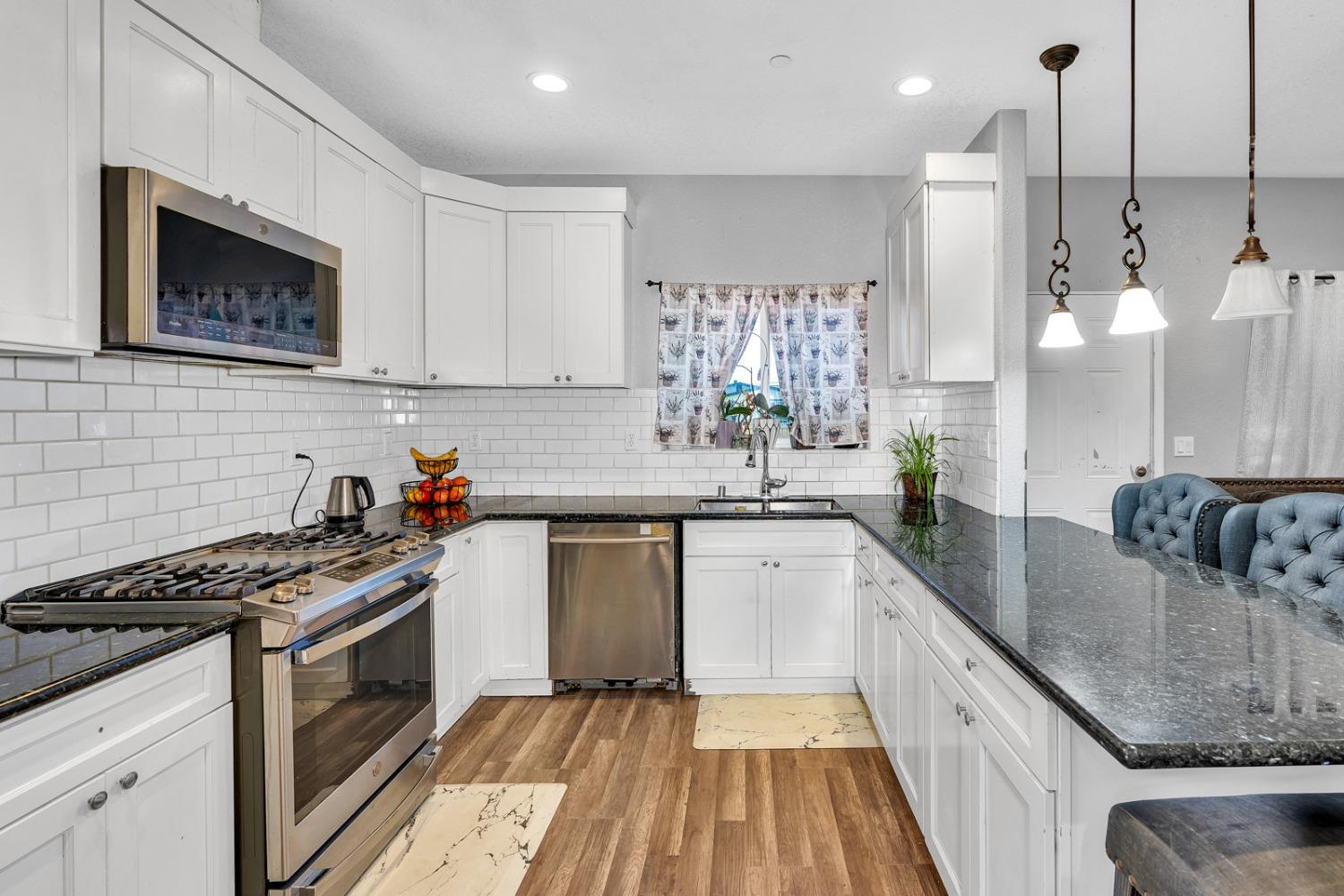 509 Kerr Avenue Modesto, CA 95354 - Photo 20 of 55 a kitchen with stainless steel appliances granite countertop a sink stove and refrigerator