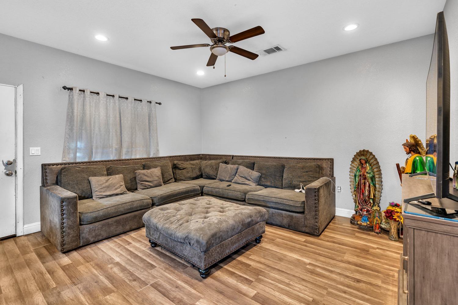 509 Kerr Avenue Modesto, CA 95354 - Photo 26 of 55 a living room with furniture ceiling fan and a rug