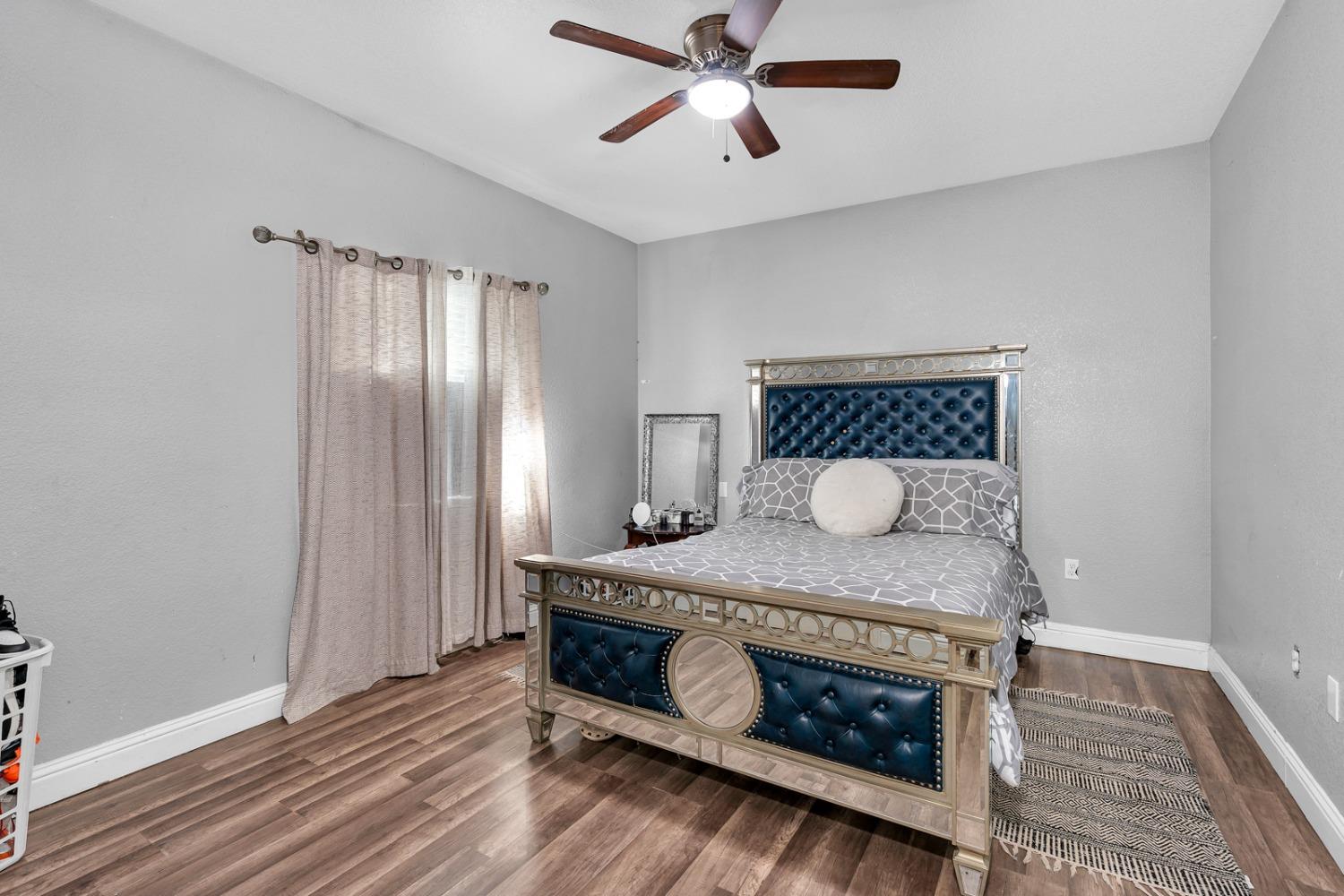 509 Kerr Avenue Modesto, CA 95354 - Photo 39 of 55 a bedroom with a bed and wooden floor