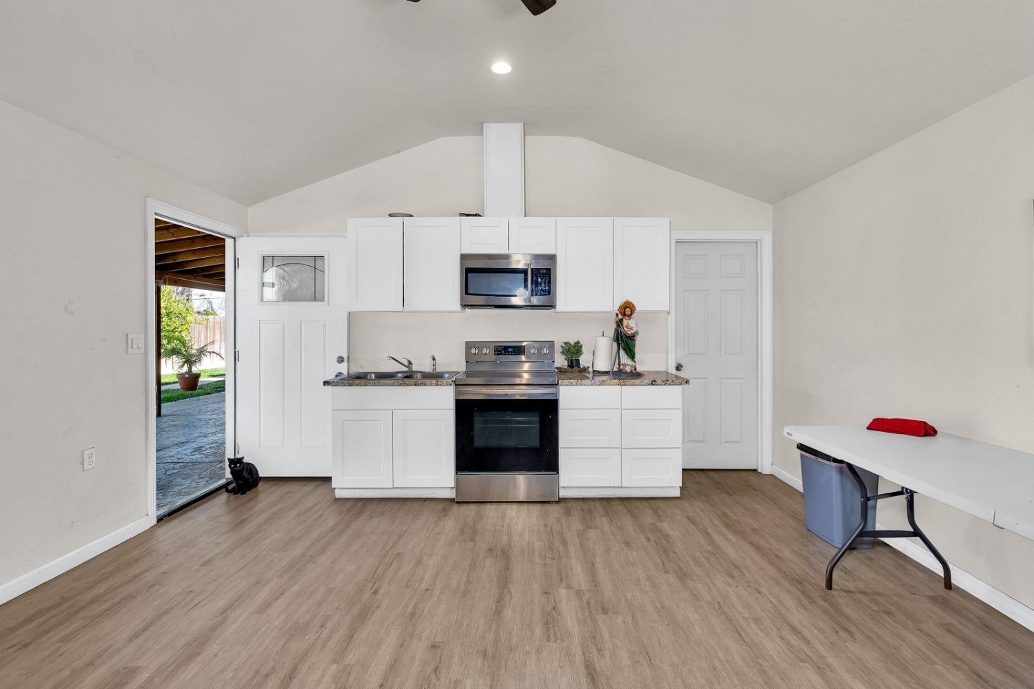 509 Kerr Avenue Modesto, CA 95354 - Photo 42 of 55 a kitchen with a refrigerator and a stove top oven