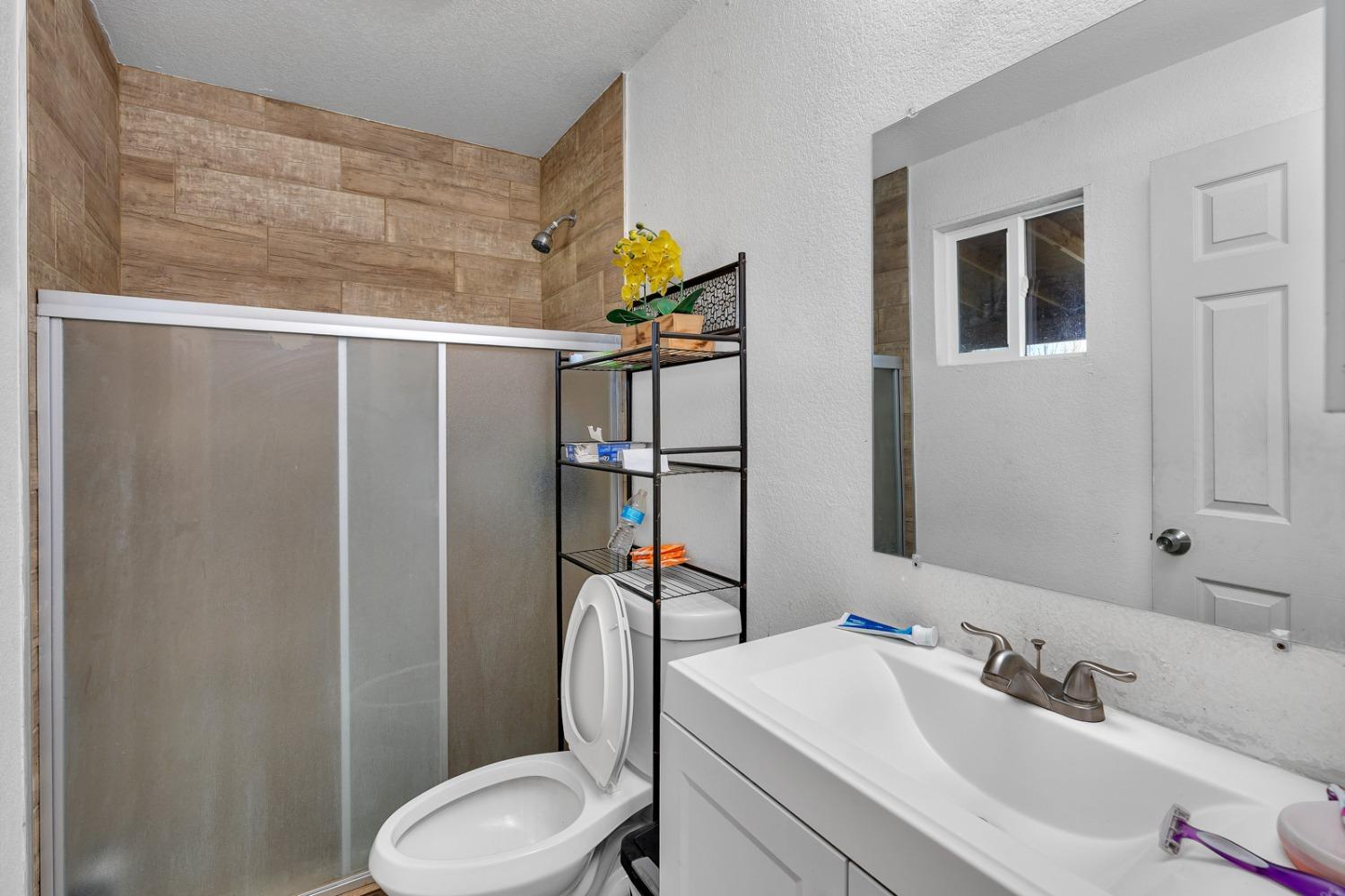 509 Kerr Avenue Modesto, CA 95354 - Photo 46 of 55 a bathroom with a sink toilet and shower
