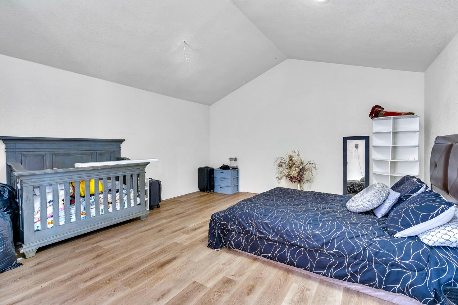 509 Kerr Avenue Modesto, CA 95354 - Photo 49 of 55 a bedroom with a bed and wooden floor