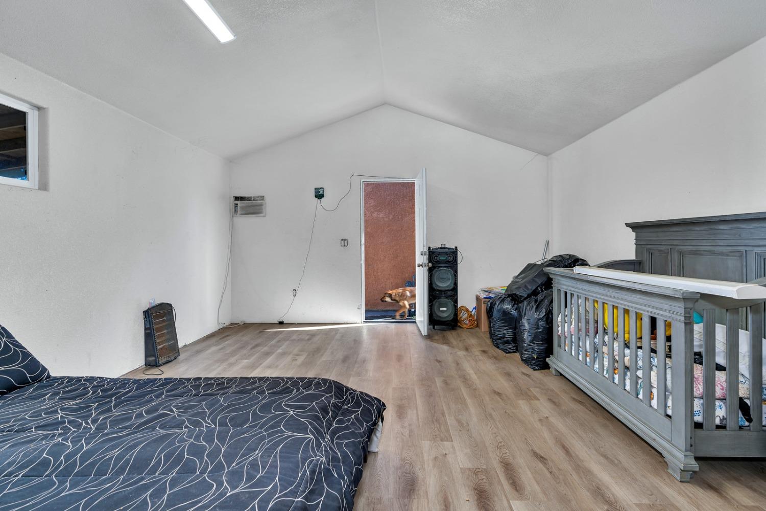 509 Kerr Avenue Modesto, CA 95354 - Photo 50 of 55 a bedroom with a bed and wooden floor