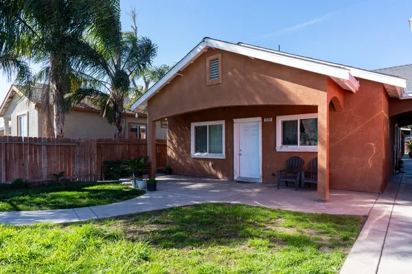 a front view of a house with a yard and porch