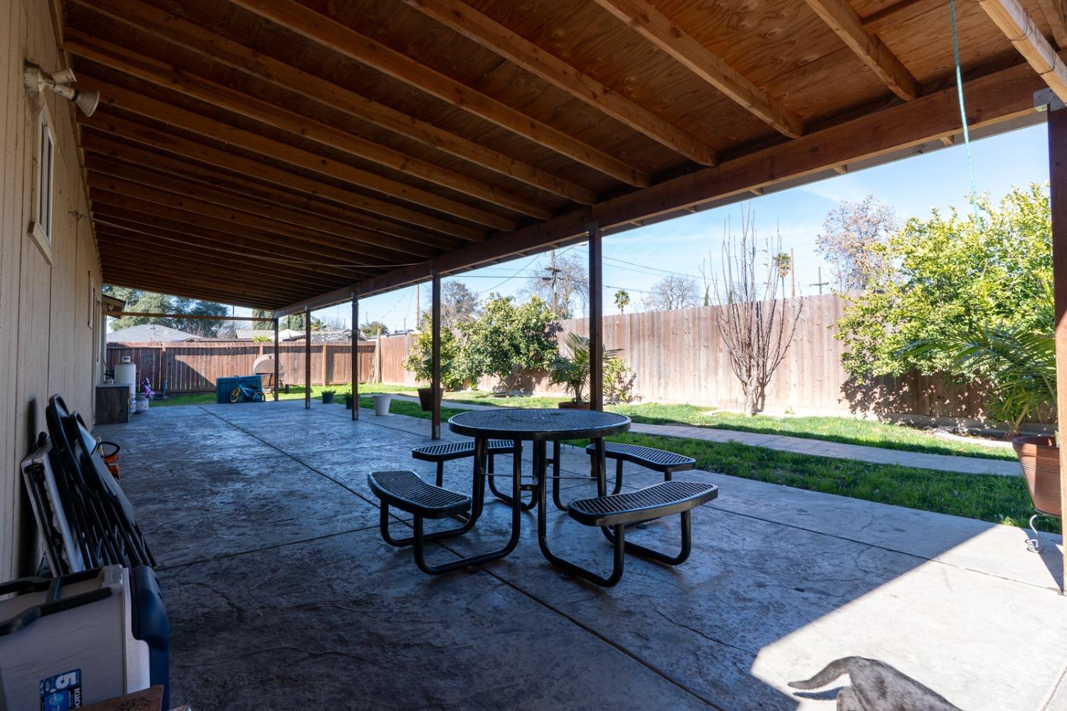 509 Kerr Avenue Modesto, CA 95354 - Photo 53 of 55 a view of a patio with table and chairs with plants and garden