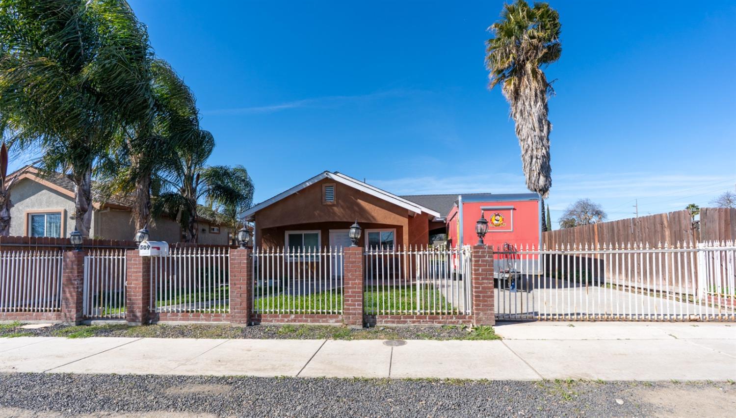 509 Kerr Avenue Modesto, CA 95354 - Photo 6 of 55 a front view of a house with a garden and plants