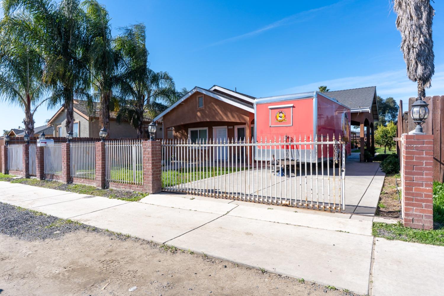 509 Kerr Avenue Modesto, CA 95354 - Photo 7 of 55 a view of a small yard in front of a house with wooden fence