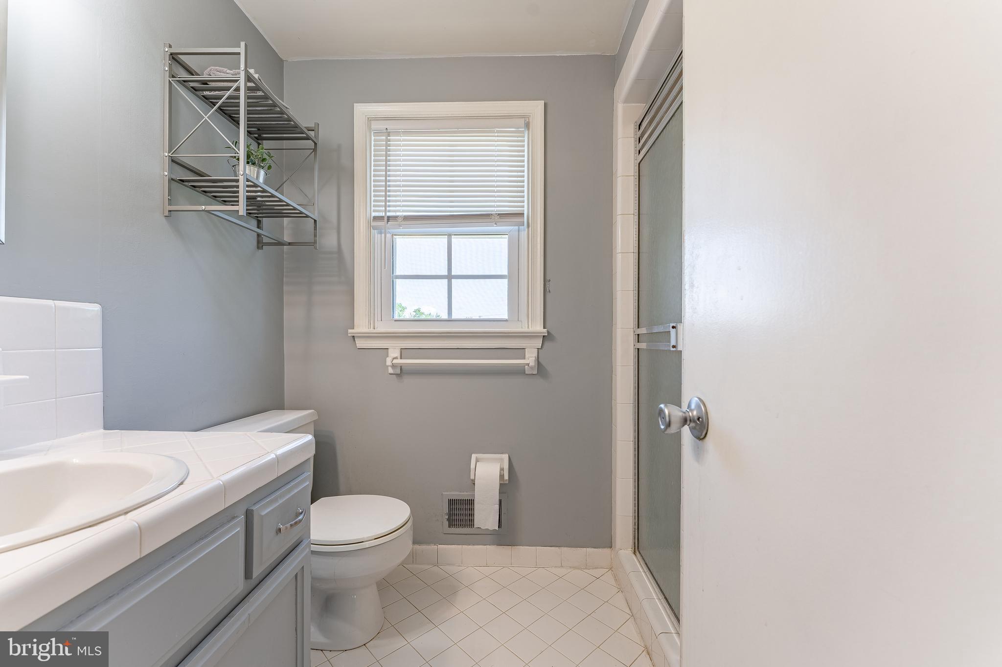 84 North Spring Lane Phoenixville, PA 19460 - Photo 31 of 51 a bathroom with a granite countertop toilet a sink and a mirror