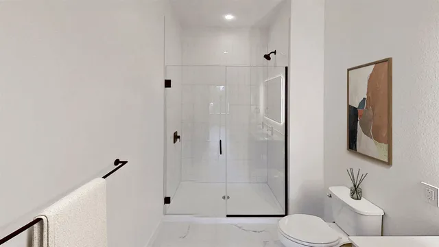 a bathroom with a toilet sink and shower