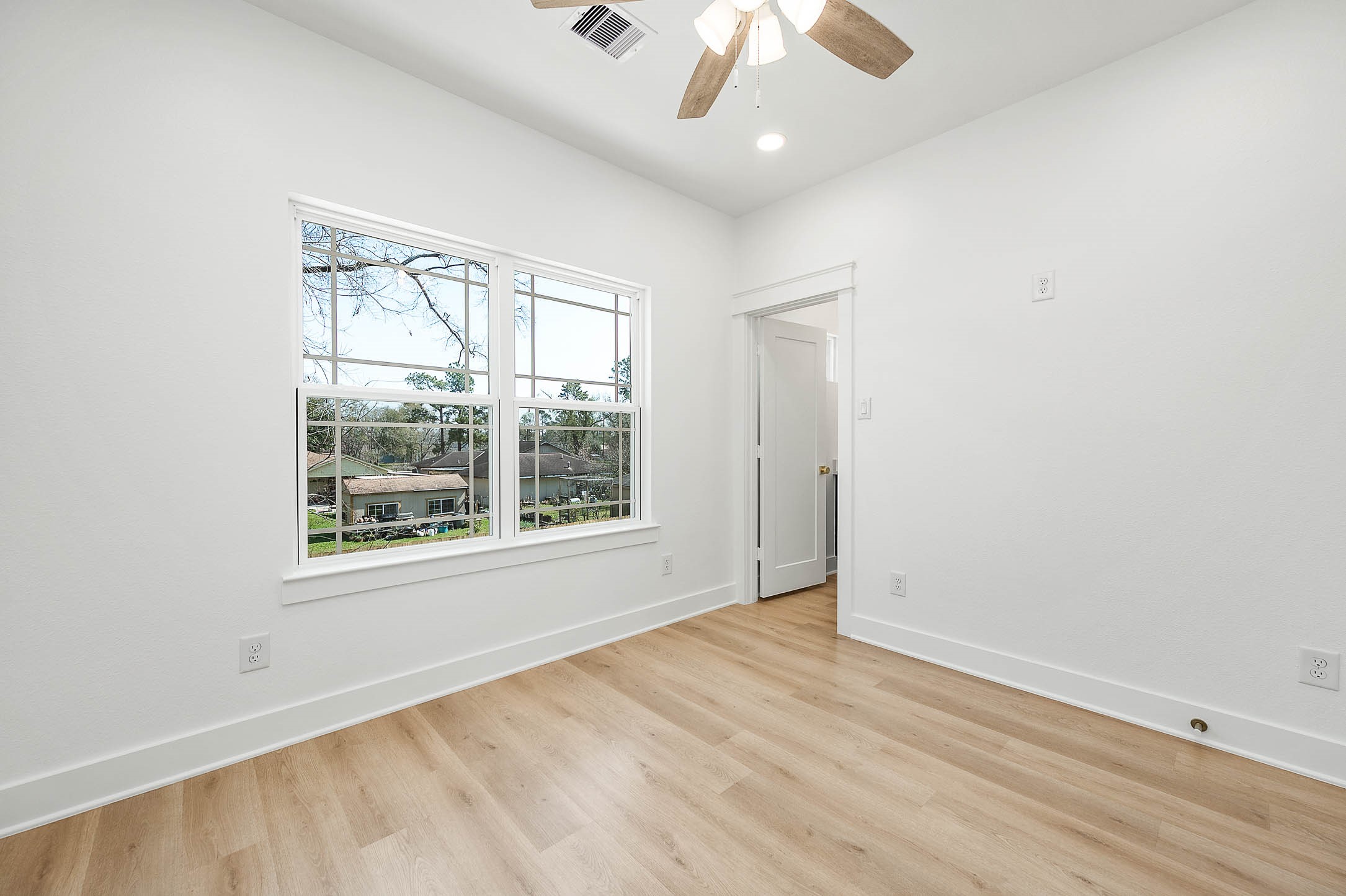8602 Hoffman Street Houston, TX 77016 - Photo 26 of 30 Third bedroom with large windows, clean finishes, and a neutral palette. perfect for guests, a home office, or a growing household.