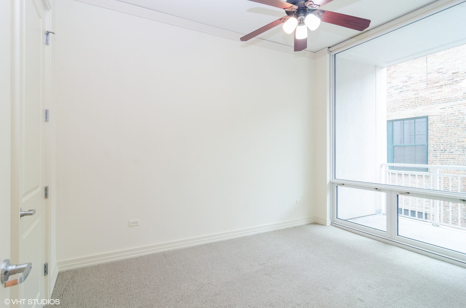 170 West Polk Street, Unit 906 Chicago, IL 60605 - Photo 12 of 18 an empty room with a chandelier fan and windows
