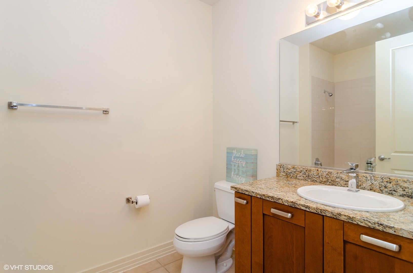 170 West Polk Street, Unit 906 Chicago, IL 60605 - Photo 14 of 18 a bathroom with a granite countertop sink toilet and a mirror
