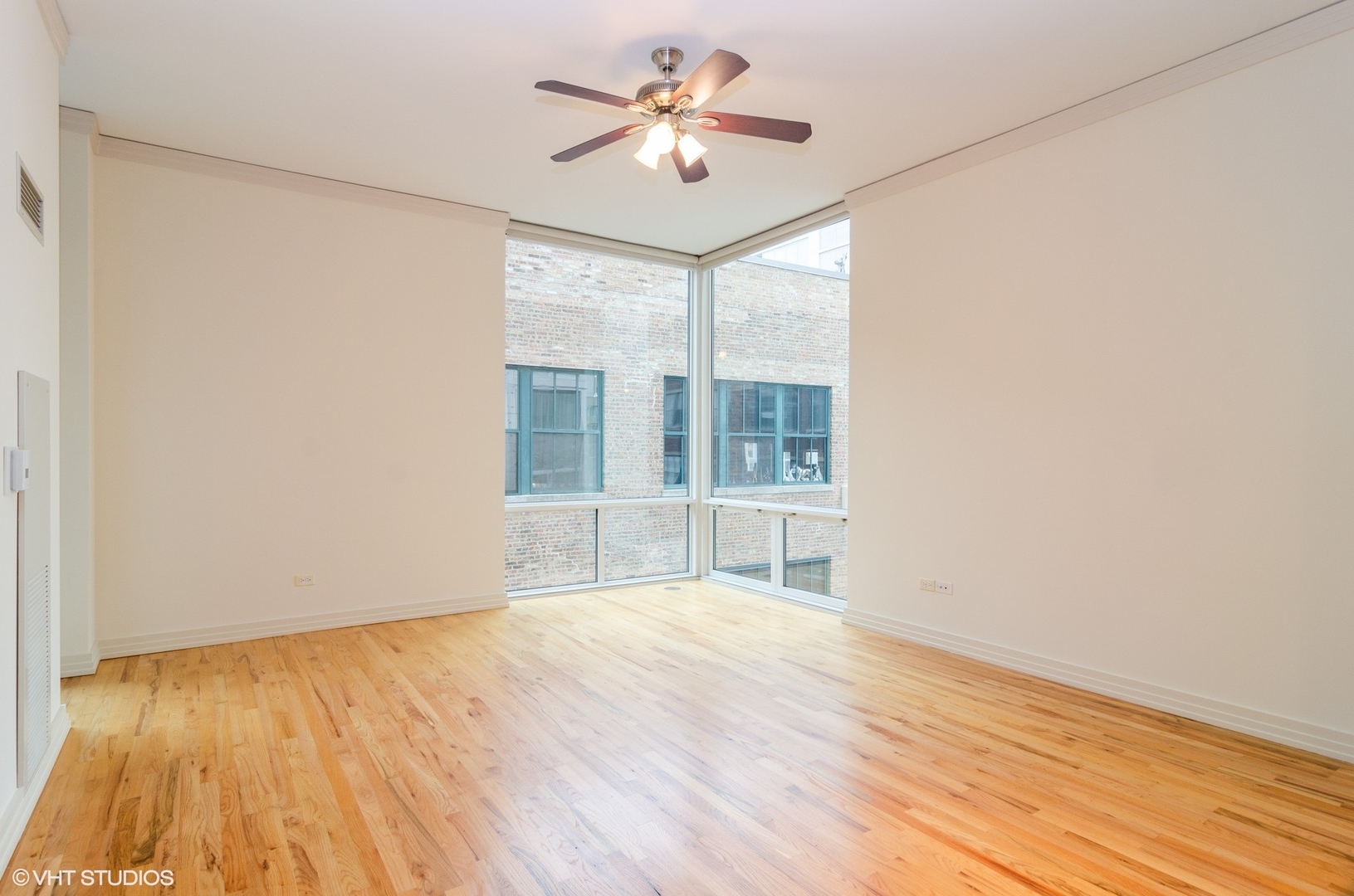 170 West Polk Street, Unit 906 Chicago, IL 60605 - Photo 6 of 18 a view of an empty room with a window and wooden floor